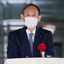 Yoshihide Suga wearing a face mask at a press conference
