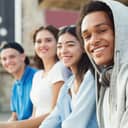 A group of teenagers posing for a close-up photo while seating
