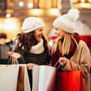 Happy women friends shopping for Christmas presents