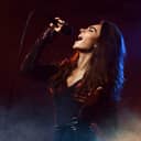 Woman singing passionately into a microphone