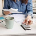 A closeup of a young woman sorting her bills