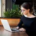 Woman working on laptop inside a cafe