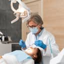 Close-up of an experienced female dentist conducting a medical examination on her patient.