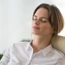 Relaxed woman with a calm face resting.