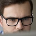 Man wearing glasses looking at a screen