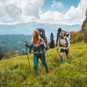 Family hiking in mountains travel adventure vacations group hikers couple with baby trekking outdoor healthy lifestyle eco tourism