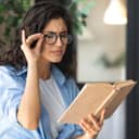 Woman suspiciously looking at a book she is holding