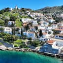 Aerial view of the charming seaside village and harbor of Kaminia in the Saronic Gulf of Greece.