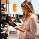 A woman looking at shoes in a shoe shop.