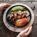 close-up top view of a waiter serving beautifully arranged baked veal with fresh fruits