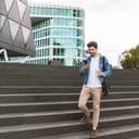 Man using his smartphone while walking in a city