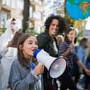 Young girl speaking through a megaphone during a rally
