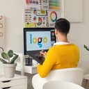 A designer creating a logo on their graphic tablet
