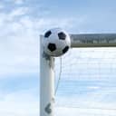 A soccer ball hitting a goalpost