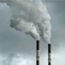 Thick smoke coming out of two industrial chimneys