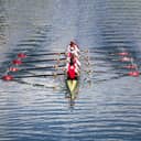 Rowing boat team in action in water