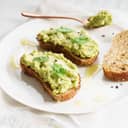 A highly nutritious breakfast toast topped with smashed avocado.