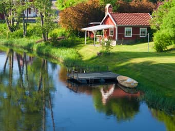 Cute and rural house next to a lake.