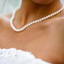 A woman wearing a white pearl necklace 