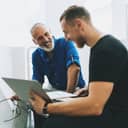 Two men having a conversation in a business environment