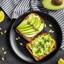 Two avocado sandwiches on a platter