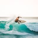 professional surfer catching waves in Bali, Indonesia, alone in the ocean