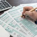 A person filling out forms
