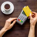 Top-down photo of a person paying for a coffee using a credit card
