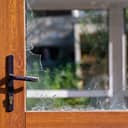 close-up of a modern door with shattered glass close to door handle