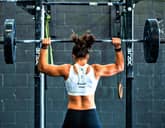 Woman doing an overhead press at the gym
