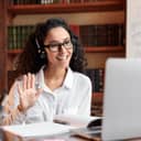 An online teacher waving hello to a student