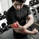 Artistic depiction of a gymgoer experiencing pain in his right hand elbow area