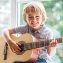 Small boy playing the guitar