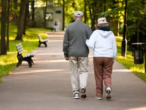 A senior couple walking in a park