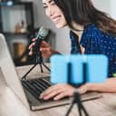 A young woman talking in a microphone while streaming herself online