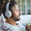 Man listens to music on his earphones indoors