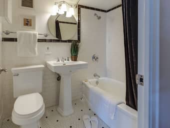 Modern bathroom with a bright light over the sink.