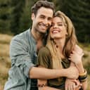 Portrait of a caring young couple hugging each other with big smiles on their faces.