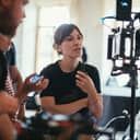 Filmmakers at a set looking at a camera screen