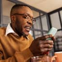 Man using his smartphone with both hands