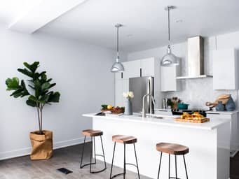 White kitchen with an island in the middle.