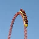 People riding a tall rollercoaster