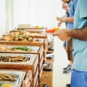 buffet with people enjoying an all-you-can-eat dining setup at a celebration event
