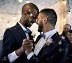 Wedding couple touching their brows while embraced in a dance