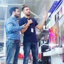 Salesman talking about a TV product to a potential buyer