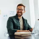 happy businessman engaged in a discussion in an office boardroom meeting with colleagues