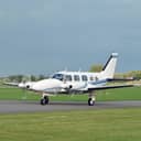 A small airplane landing on a private airstrip