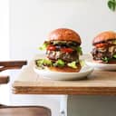 Two large hamburgers served on platters