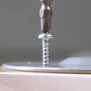 Closeup of a screw being secured into a surface