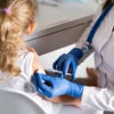 little girl being vaccinated at the doctor's office